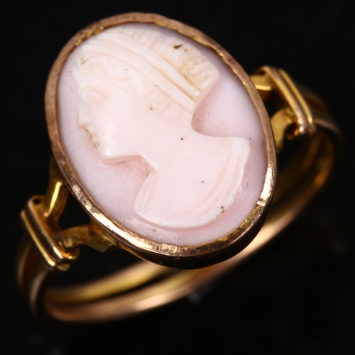 165 - An unmarked gold relief carved pink coral cameo ring, depicting female profile, setting height 16mm,... 