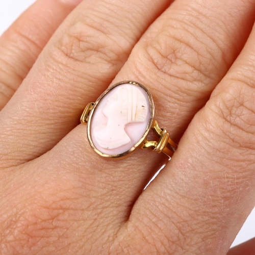 165 - An unmarked gold relief carved pink coral cameo ring, depicting female profile, setting height 16mm,... 