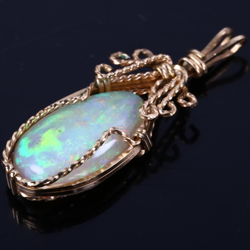 166 - A late 20th century white opal pendant, unmarked gold wirework settings with pear cabochon opal, opa... 