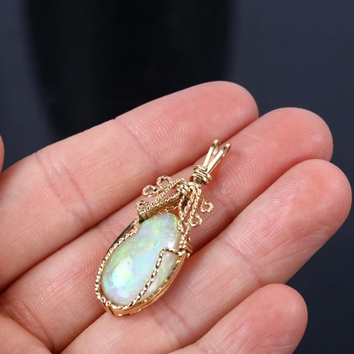 166 - A late 20th century white opal pendant, unmarked gold wirework settings with pear cabochon opal, opa... 