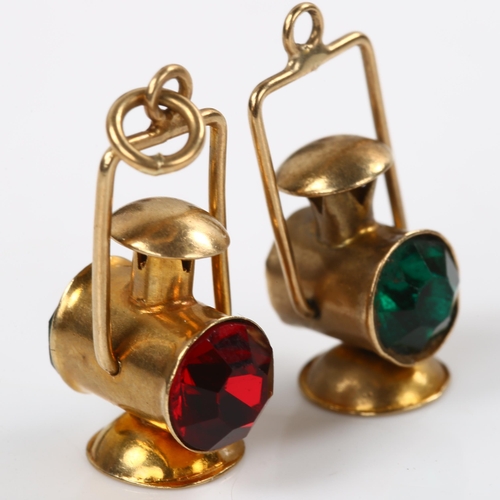 175 - A pair of 9ct gold novelty ship/railway signal lantern pendants/fobs, inset with red and green glass... 