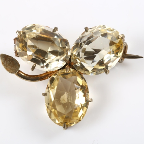 177 - A citrine shamrock brooch, unmarked gilt-metal settings with oval mixed-cut citrine, brooch length 2... 