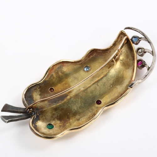 184 - A large Art Deco gem set leaf brooch, unmarked gold and silver settings, gemstones include emerald r... 