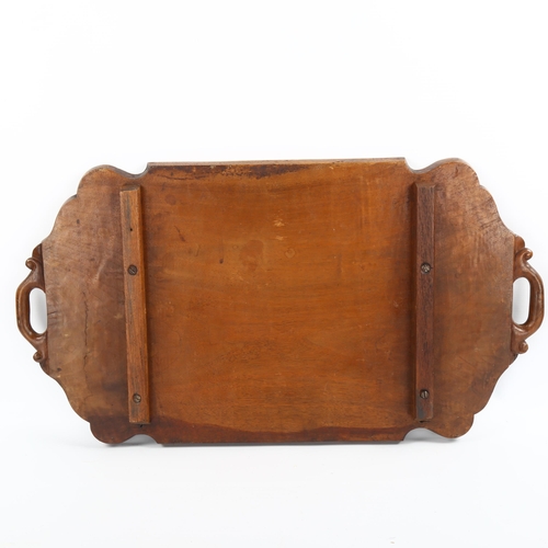 1009 - An Indian hardwood tray with relief carved bats and snakes, in moulded surround, length 60cm