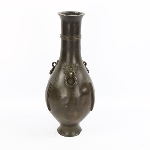 1070 - A Chinese patinated bronze narrow-neck vase, with 3 ring handles and mask mounts, 18th or 19th centu... 