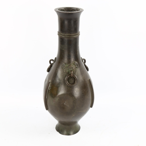 1070 - A Chinese patinated bronze narrow-neck vase, with 3 ring handles and mask mounts, 18th or 19th centu... 