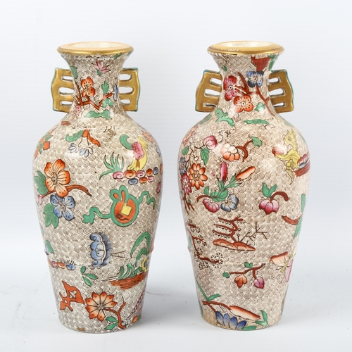 1082 - A pair of 19th century chinoiserie transfer printed vases with gilded neck handles, no factory marks... 