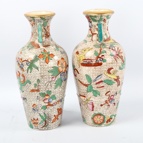 1082 - A pair of 19th century chinoiserie transfer printed vases with gilded neck handles, no factory marks... 