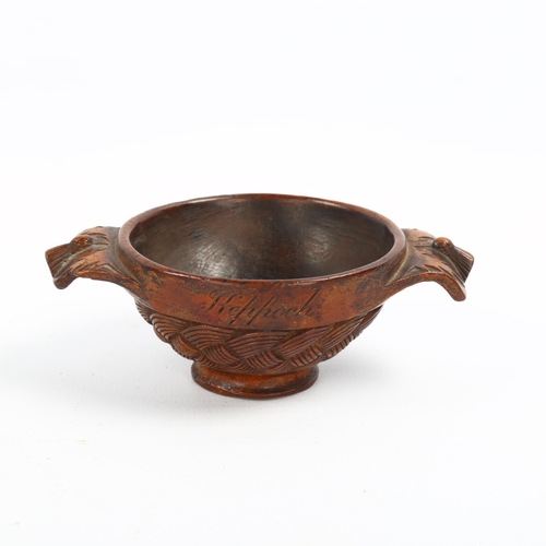 1087 - A 19th century Scottish treen quaich, the body carved with basketweave design, lug handles carved wi... 