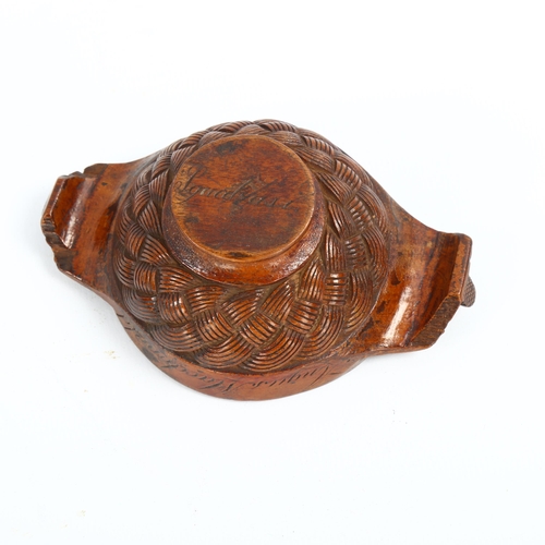 1087 - A 19th century Scottish treen quaich, the body carved with basketweave design, lug handles carved wi... 