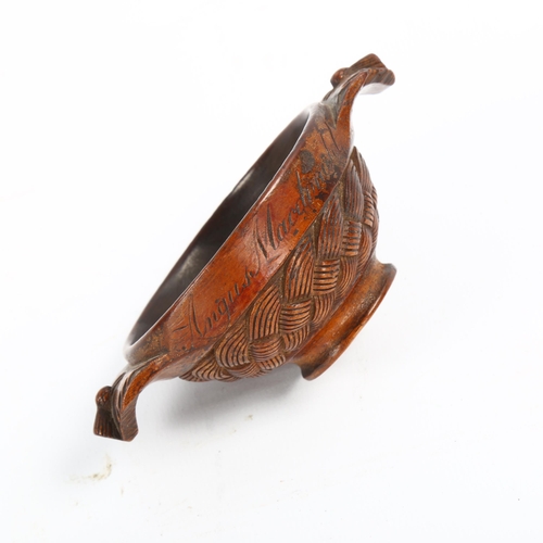 1087 - A 19th century Scottish treen quaich, the body carved with basketweave design, lug handles carved wi... 