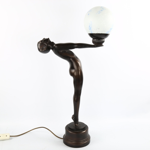 1120 - A reproduction Art Deco style composition lamp, in the form of a naked figure with marbled glass bal... 