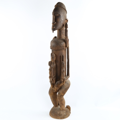 1135 - A large African Dogon Tribal carved wood fertility figure, height 90cm