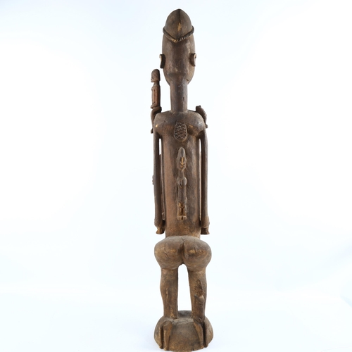 1135 - A large African Dogon Tribal carved wood fertility figure, height 90cm