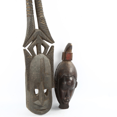 1137 - African Dogon Tribal carved wood mask, height 37cm, and another African carved wood horned mask, len... 