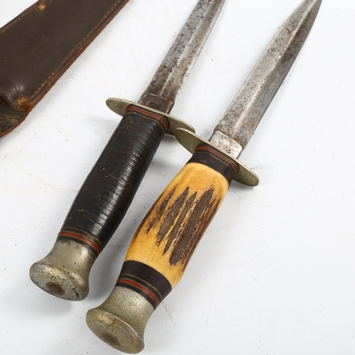 1162 - 2 Second World War period daggers in sheaths, both with makers marks William Rodgers, Sheffield, lon... 