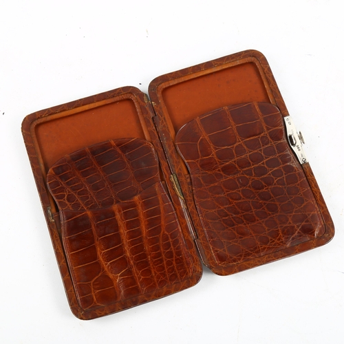 1169 - A Victorian crocodile skin cigar case with silver clip, hallmarks London 1888, 17cm x 10cm