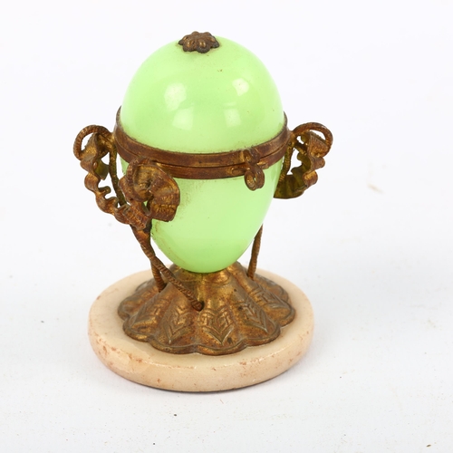 1174 - A French Palais Royale green opaline glass and ormolu mounted egg-shaped box on polished stone base,... 