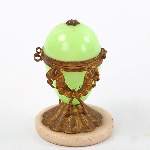 1174 - A French Palais Royale green opaline glass and ormolu mounted egg-shaped box on polished stone base,... 