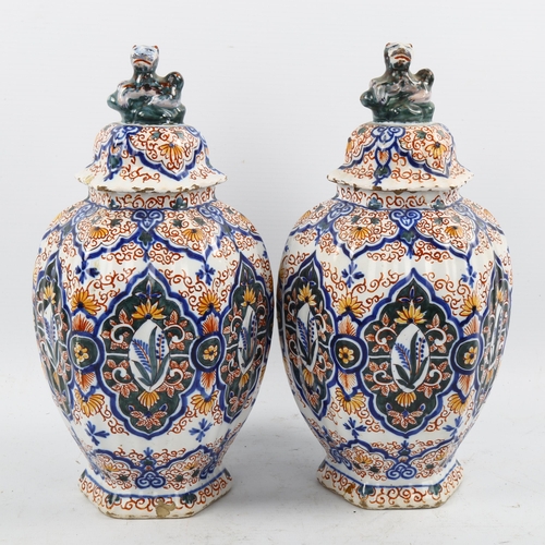 1190 - A pair of Delft pottery jars and covers, 18th/19th century with chinoiserie decoration and lion fini... 