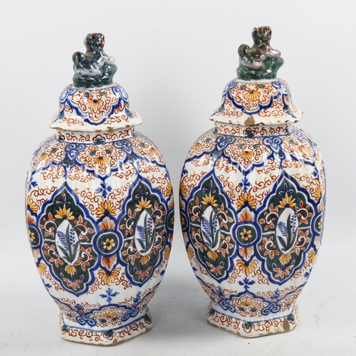 1190 - A pair of Delft pottery jars and covers, 18th/19th century with chinoiserie decoration and lion fini... 