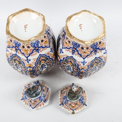 1190 - A pair of Delft pottery jars and covers, 18th/19th century with chinoiserie decoration and lion fini... 