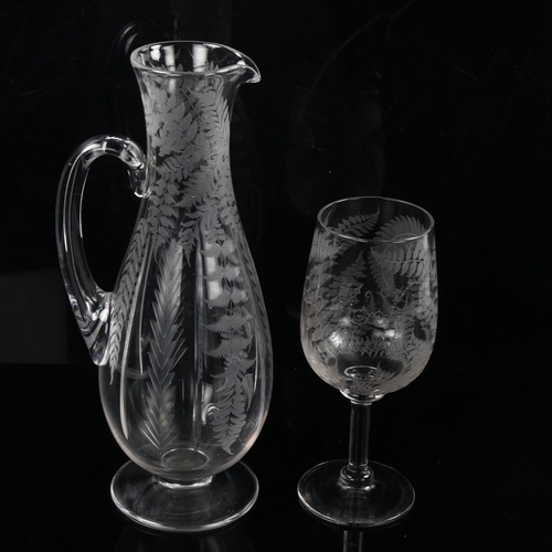 1198 - A Victorian glass wine ewer and matching stemmed glass, with wheel-cut fern decoration, glass inscri... 