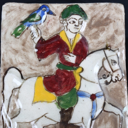 1199 - An Islamic relief moulded and painted pottery tile depicting a huntsman, 19.5cm x 14.5cm