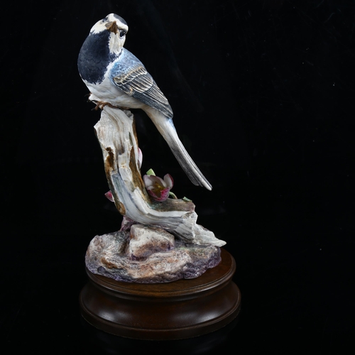 1214 - Hereford limited edition china bird on a branch, on wood plinth, height 27cm