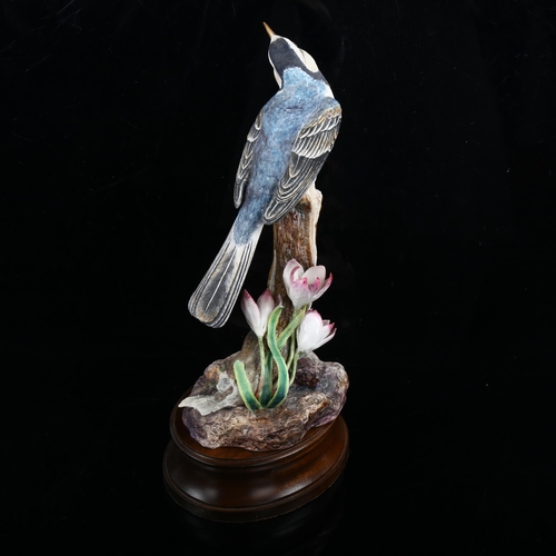 1214 - Hereford limited edition china bird on a branch, on wood plinth, height 27cm