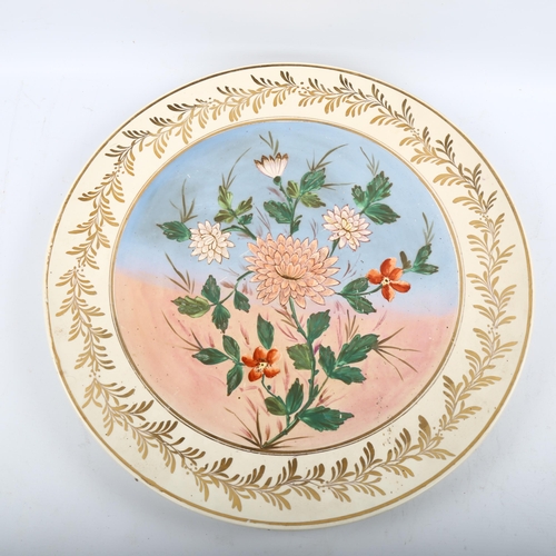 1219 - A large Royal Doulton pottery charger, with painted floral panel, diameter 50cm