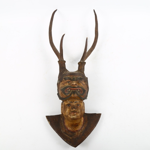 1222 - A Burmese/Indian wood and plaster wall mask with antlers, length 53cm