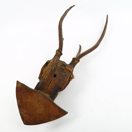 1222 - A Burmese/Indian wood and plaster wall mask with antlers, length 53cm