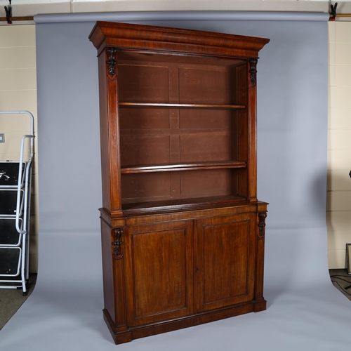 1233 - A 19th century mahogany 2-door cupboard with open bookshelves above and carved pilasters, width 121c... 