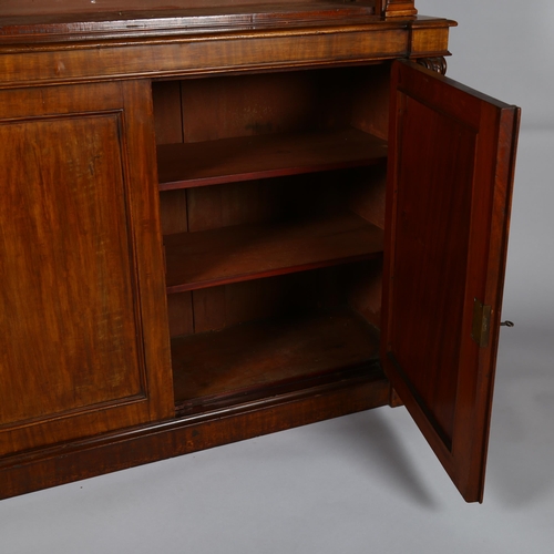 1233 - A 19th century mahogany 2-door cupboard with open bookshelves above and carved pilasters, width 121c... 