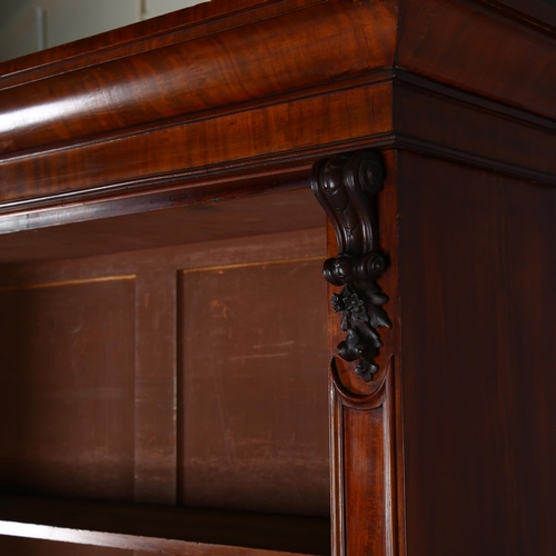 1233 - A 19th century mahogany 2-door cupboard with open bookshelves above and carved pilasters, width 121c... 