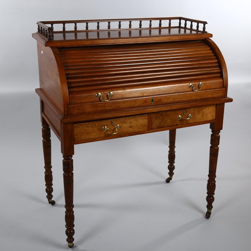 1243 - A Victorian walnut roll-top desk with tambour-front opening to reveal a pull-out leather-topped writ... 