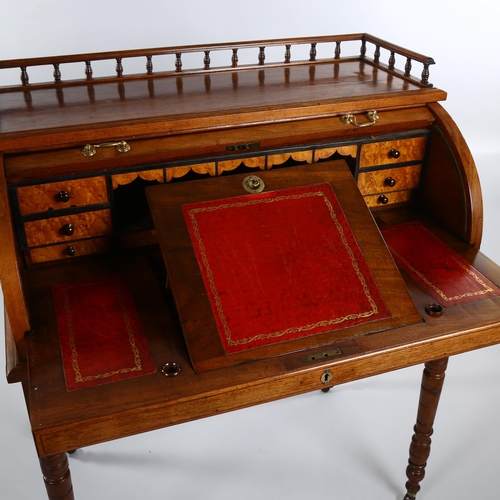 1243 - A Victorian walnut roll-top desk with tambour-front opening to reveal a pull-out leather-topped writ... 