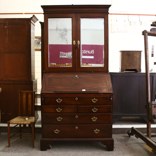 1246 - An impressive George III flame veneer mahogany bureau bookcase, with bevel mirror panelled cupboards... 