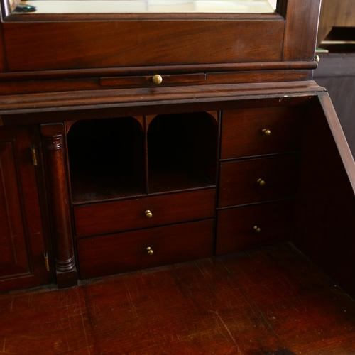 1246 - An impressive George III flame veneer mahogany bureau bookcase, with bevel mirror panelled cupboards... 