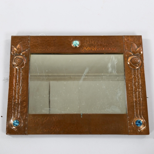 1253 - LIBERTY - Art Nouveau copper-framed wall mirror, with relief embossed surround and inset Ruskin pane... 