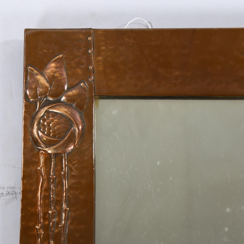 1253 - LIBERTY - Art Nouveau copper-framed wall mirror, with relief embossed surround and inset Ruskin pane... 