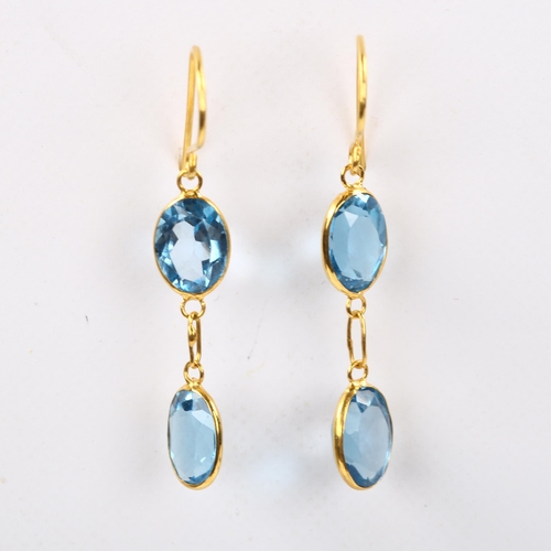 203 - A pair of 14ct gold blue topaz drop earrings, bezel set with oval mixed-cut topaz and shepherd hook ... 