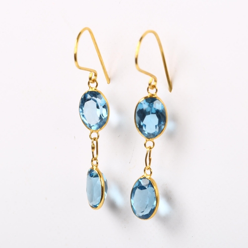 203 - A pair of 14ct gold blue topaz drop earrings, bezel set with oval mixed-cut topaz and shepherd hook ... 