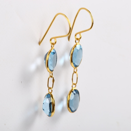 203 - A pair of 14ct gold blue topaz drop earrings, bezel set with oval mixed-cut topaz and shepherd hook ... 