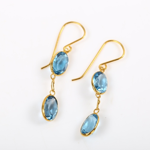 203 - A pair of 14ct gold blue topaz drop earrings, bezel set with oval mixed-cut topaz and shepherd hook ... 