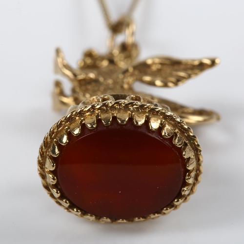 204 - A 9ct gold carnelian figural griffon fob seal, on gilt-metal fine curb link chain, fob height 31.2mm... 