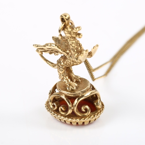 204 - A 9ct gold carnelian figural griffon fob seal, on gilt-metal fine curb link chain, fob height 31.2mm... 