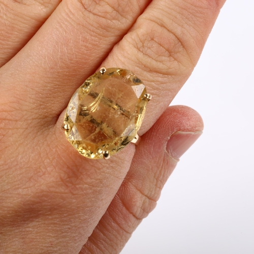 207 - A large 14ct gold citrine dress ring, set with oval mixed-cut citrine, length 22.4mm, size M, 7g