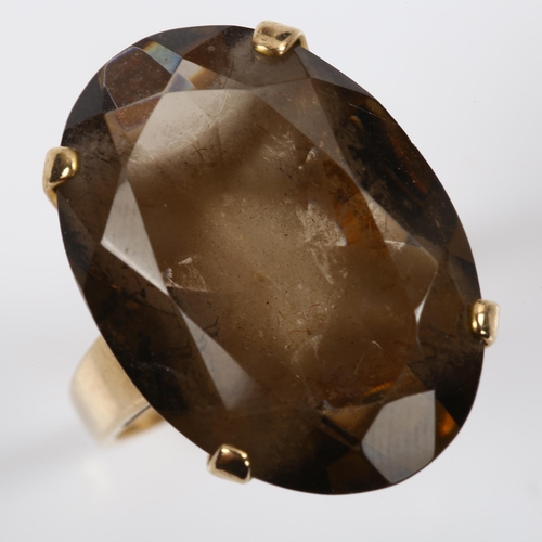 212 - A large late 20th century 9ct gold smoky quartz dress ring, set with oval mixed-cut quartz, length 2... 